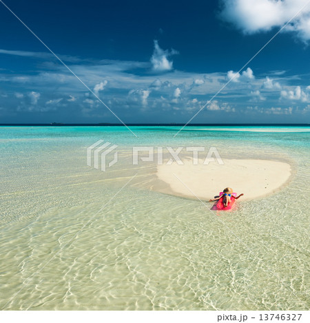 Woman relaxing on inflatable mattress 13746327