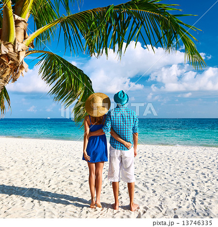 Couple in blue clothes on a beach at Maldives 13746335