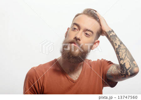 Handsome bearded man with hand at his fore head 13747560
