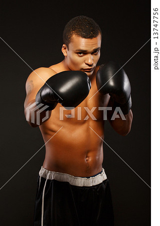 Handsome boxer posing in boxing gloves 13747756
