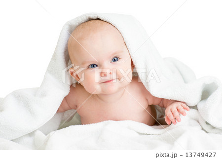 Cute smiling baby girl lying under towel after bathing 13749427
