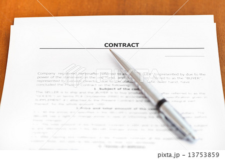 silver pen on sheet of sales contract on table silver pen on sheet of sales contract on table 13753859