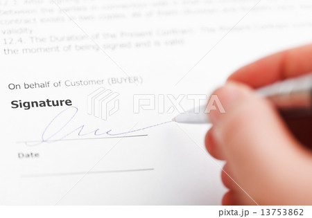 customer signing sales contract by silver pen 13753862