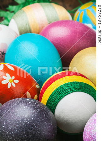 Colorful easter eggs in a wooden plate 13758230