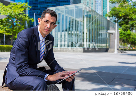 Business man sitting on bench 13759400