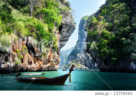 long boat and rocks on railay beach in Krabi, Thailand 13759585