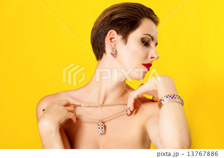 Young beautiful girl with a gold jewelry Young beautiful girl with a gold jewelry 13767886