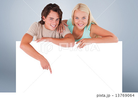 Composite image of handsome man pointing on a whiteboard with wo 13769064