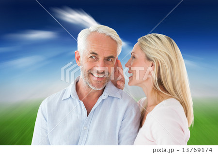 Composite image of woman whispering a secret to husband Composite image of woman whispering a secret to husband 13769174