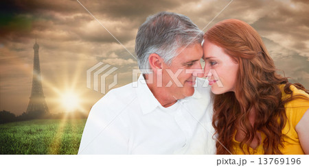 Composite image of casual couple smiling at each other 13769196