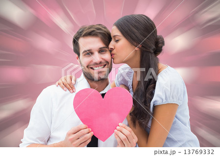 Composite image of pretty brunette giving boyfriend a kiss and h Composite image of pretty brunette giving boyfriend a kiss and h 13769332