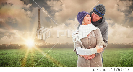 Composite image of happy mature couple in winter clothes embraci Composite image of happy mature couple in winter clothes embraci 13769418