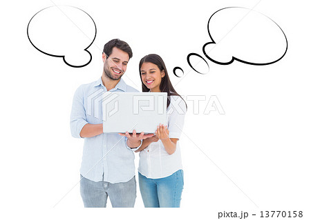 Composite image of attractive young couple holding their laptop 13770158