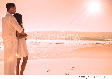 Attractive couple looking out at sea 13770408