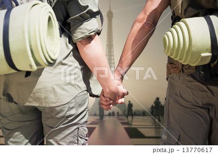 Composite image of hitch hiking couple standing holding hands on 13770617