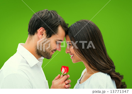 Composite image of handsome man offering his girlfriend a rose Composite image of handsome man offering his girlfriend a rose 13771347