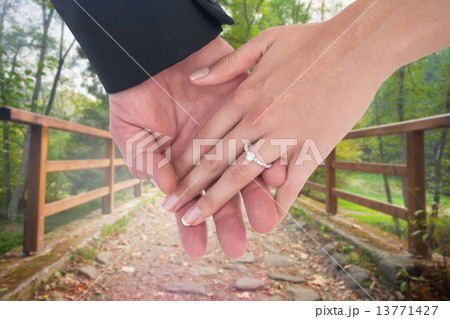 Composite image of close-up of bride and groom with hands togeth Composite image of close-up of bride and groom with hands togeth 13771427