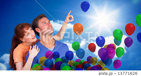Composite image of happy couple looking upwards Composite image of happy couple looking upwards 13771626