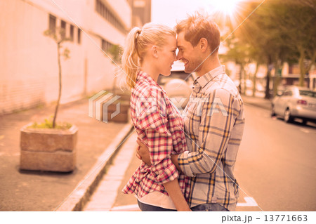 Couple in check shirts and denim hugging each other Couple in check shirts and denim hugging each other 13771663