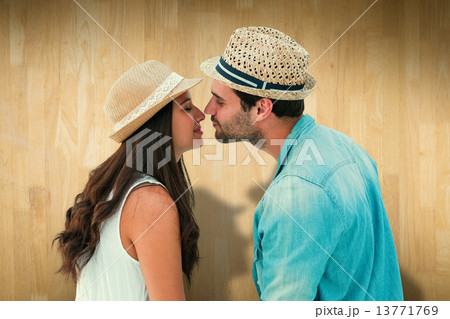 Composite image of happy hipster couple about to kiss 13771769