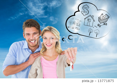 Composite image of attractive young couple showing new house key Composite image of attractive young couple showing new house key 13771875