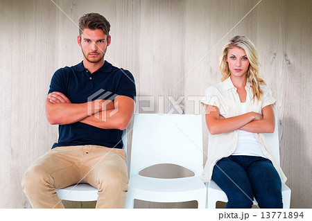 Composite image of young couple sitting in chairs not talking du Composite image of young couple sitting in chairs not talking du 13771894