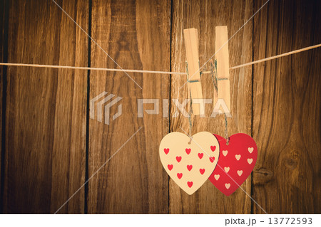 Composite image of hearts hanging on the line 13772593