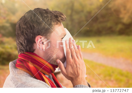 Composite image of man blowing nose on tissue Composite image of man blowing nose on tissue 13772747