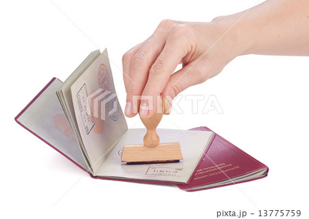 Female hand stamping a passport of Germany Female hand stamping a passport of Germany 13775759
