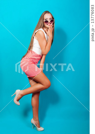 Beautiful girl with long hair in a dress and sunglasses in the studio 13776083