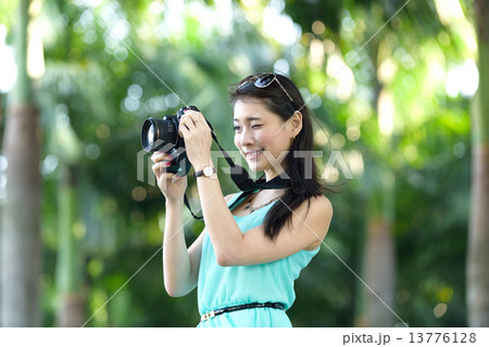 One young Chinese woman taking picture with DSLR One young Chinese woman taking picture with DSLR 13776128