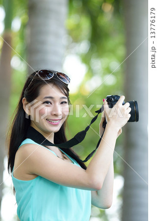 One young Chinese woman taking picture with DSLR One young Chinese woman taking picture with DSLR 13776179