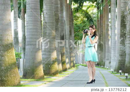 One young Chinese woman taking picture with DSLR One young Chinese woman taking picture with DSLR 13776212