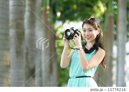 One young Chinese woman taking picture with DSLR One young Chinese woman taking picture with DSLR 13776216