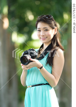 One young Chinese woman taking picture with DSLR One young Chinese woman taking picture with DSLR 13776230