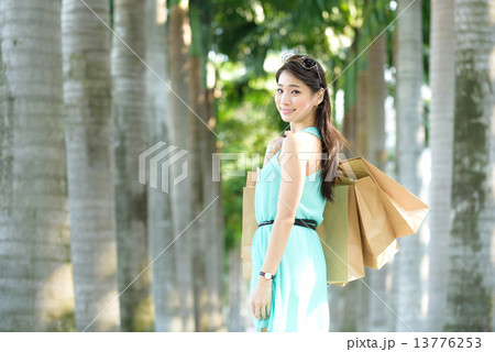 One young chinese woman shopaholic along promenade One young chinese woman shopaholic along promenade 13776253