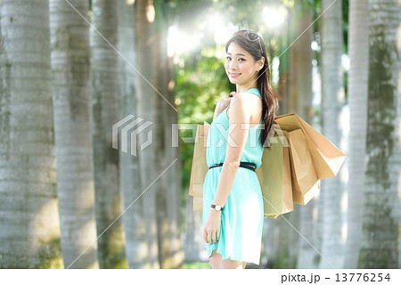 One young chinese woman shopaholic along promenade One young chinese woman shopaholic along promenade 13776254