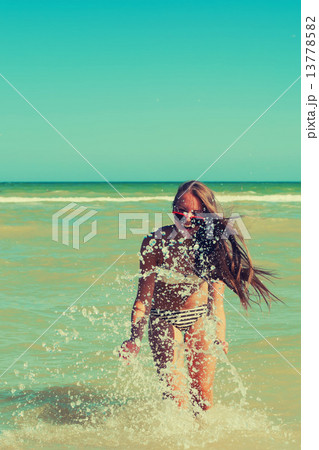 Young girl in the sea water splashes and smiling summer 13778582