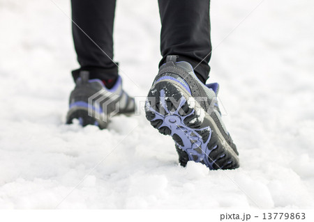 Athlete woman jogging feet on snow at morning training Athlete woman jogging feet on snow at morning training 13779863