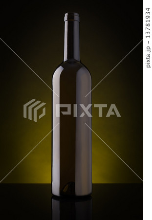 Empty wine bottle without label. On a dark background. 13781934
