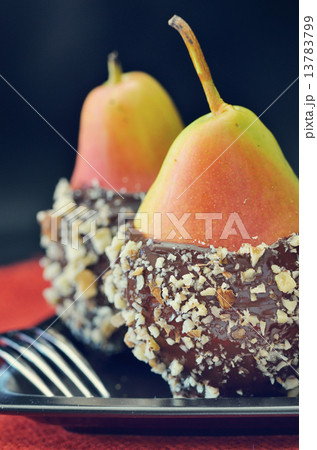 two fresh pear with chocolate icing two fresh pear with chocolate icing 13783799