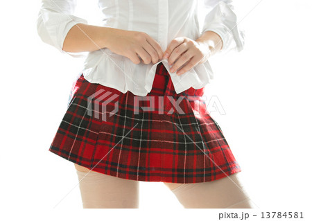 sexy woman in short skirt unbuttoning white shirt 13784581