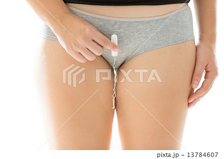 slim woman in lingerie showing how to insert tampon 13784607