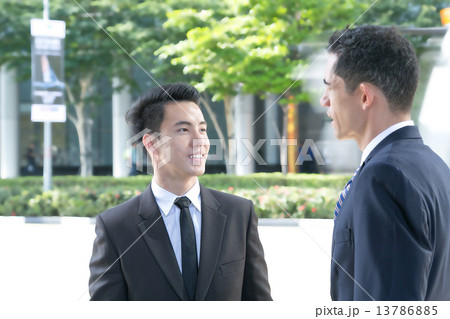 Business partners talking at the street 13786885