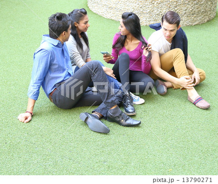 Young mixed race group chit chat on grass ground Young mixed race group chit chat on grass ground 13790271