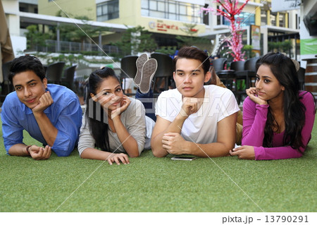 Young mixed race group posing on grass ground  13790291