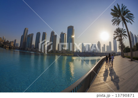 Dubai lagoon with skyscrapers against sunset in UAE Dubai lagoon with skyscrapers against sunset in UAE 13790871