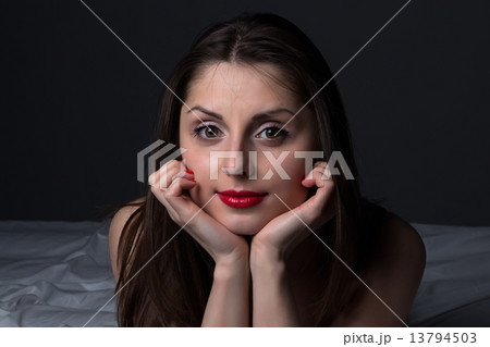 Portrait of the young brunette with red lips 13794503