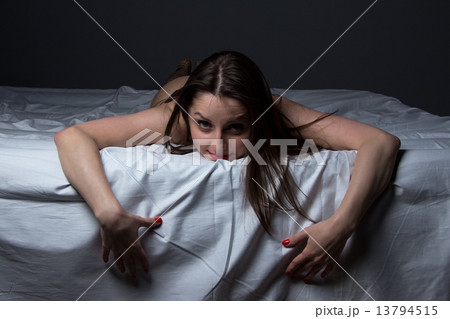 Image of young lying brunette on the bed 13794515