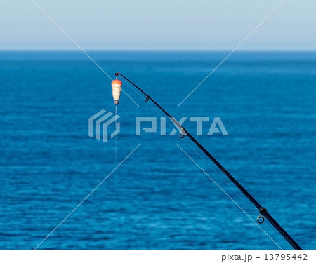 Fishing Bait-Rod with Float against the Blue Sea Water Surface Fishing Bait-Rod with Float against the Blue Sea Water Surface 13795442